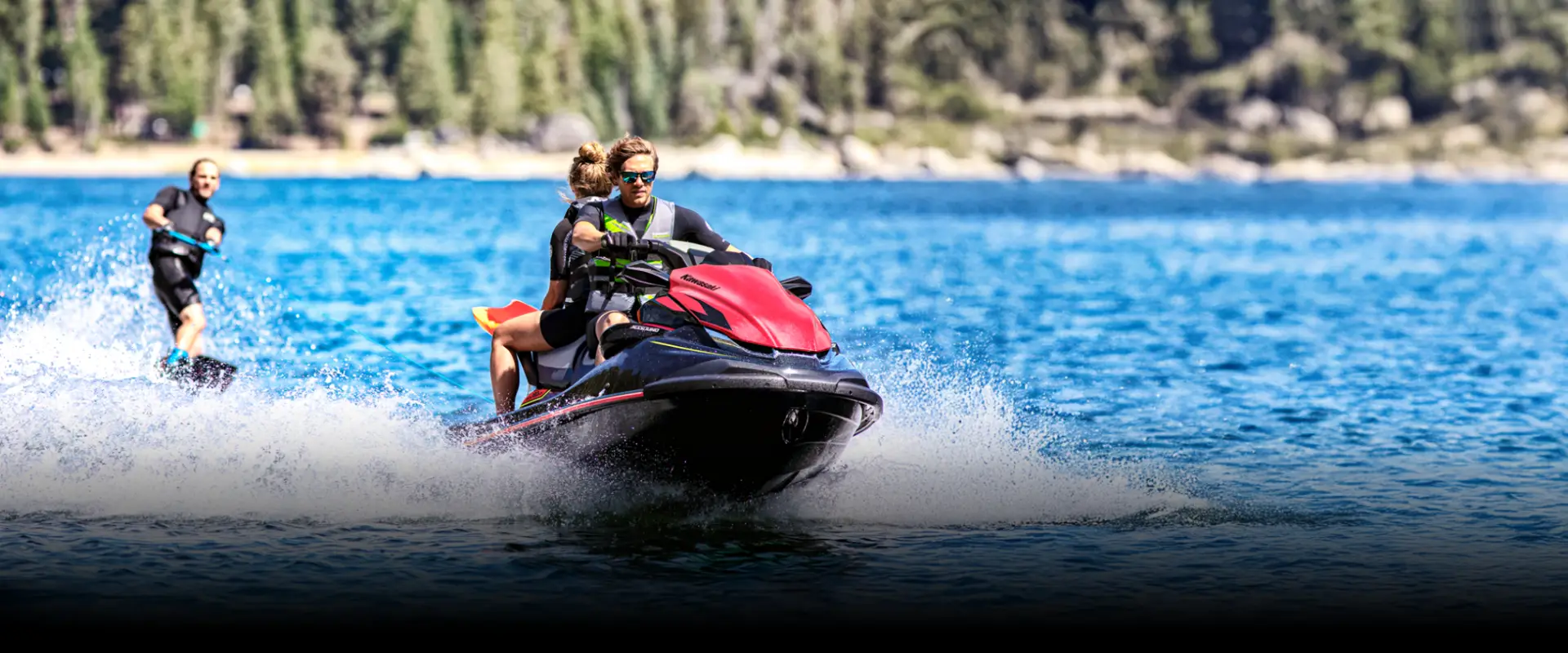 Man enjoying a Kawasaki jet ski on the water on a sunny day.