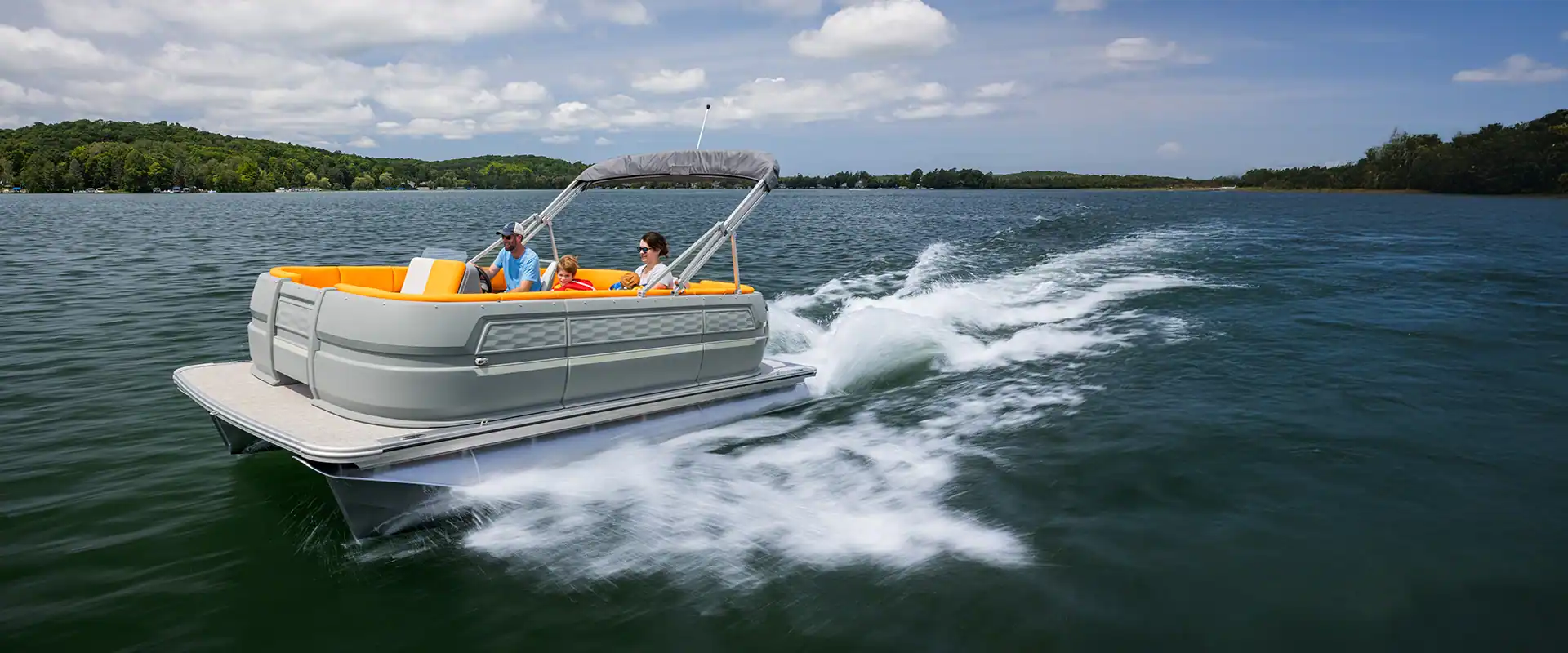  A thrilling image of a Legend pontoon boat soaring through the water.