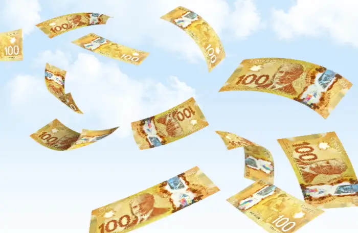 Canadian $100 bills flying in the sky.