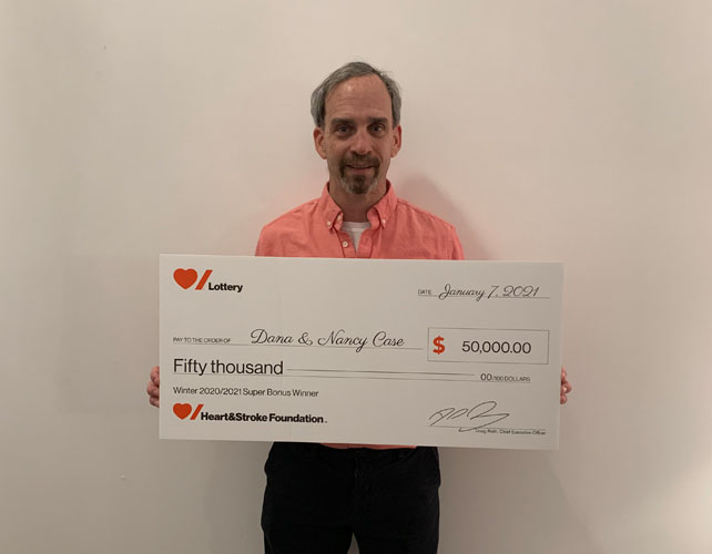 Man holding large novelty cheque