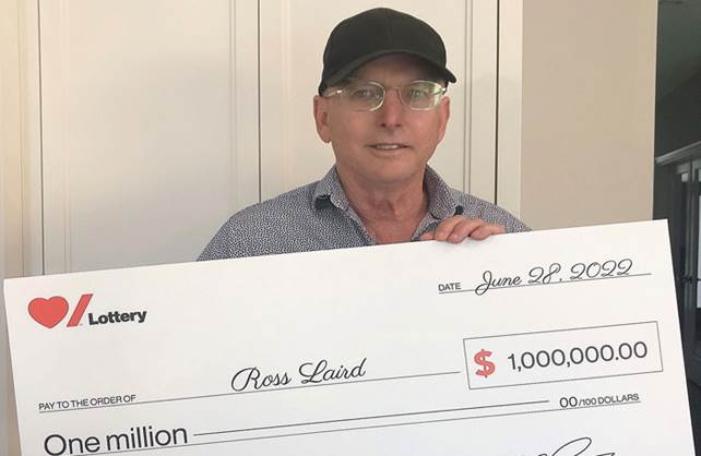 Heart & Stroke Spring 2022 Lottery Grand Prize winner Ross Laird holding his cheque for $1 million.