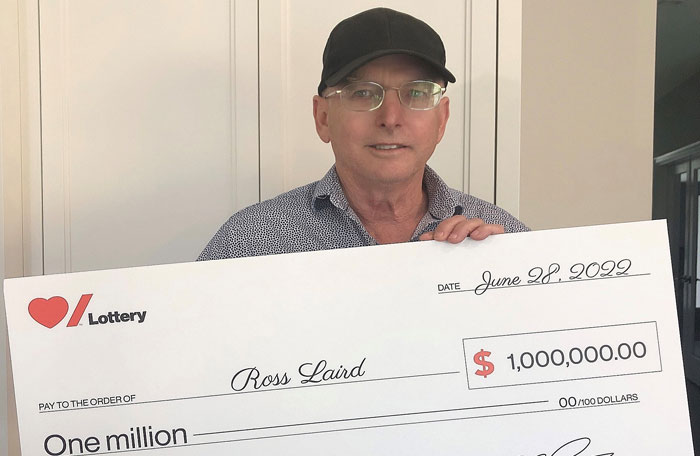 Heart & Stroke Spring 2022 Lottery Grand Prize winner Ross Laird holding his cheque for $1 million.