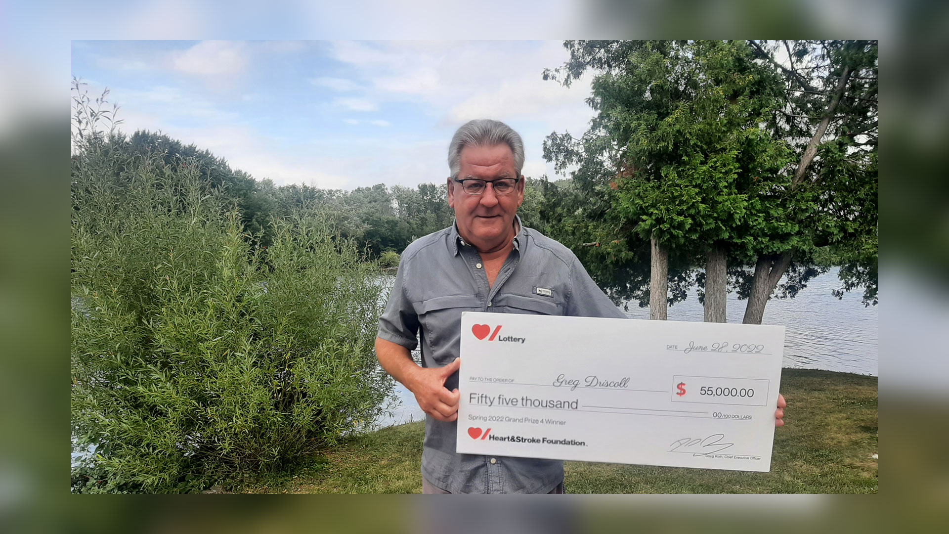 Heart & Stroke Spring 2022 Lottery Grand Prize #4 winner Greg Driscoll holding his cheque for $55,000