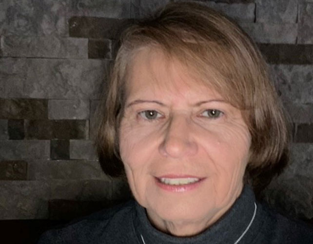 Close up of woman on stone wall background 