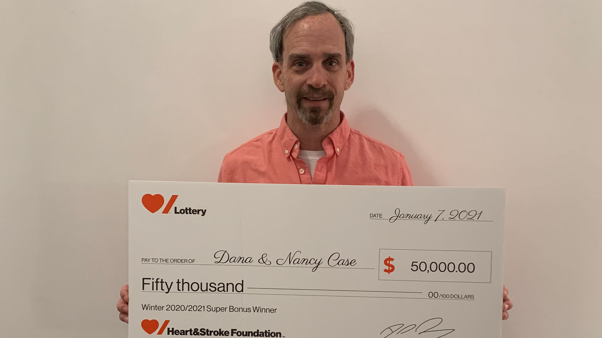 Man holding large novelty cheque 