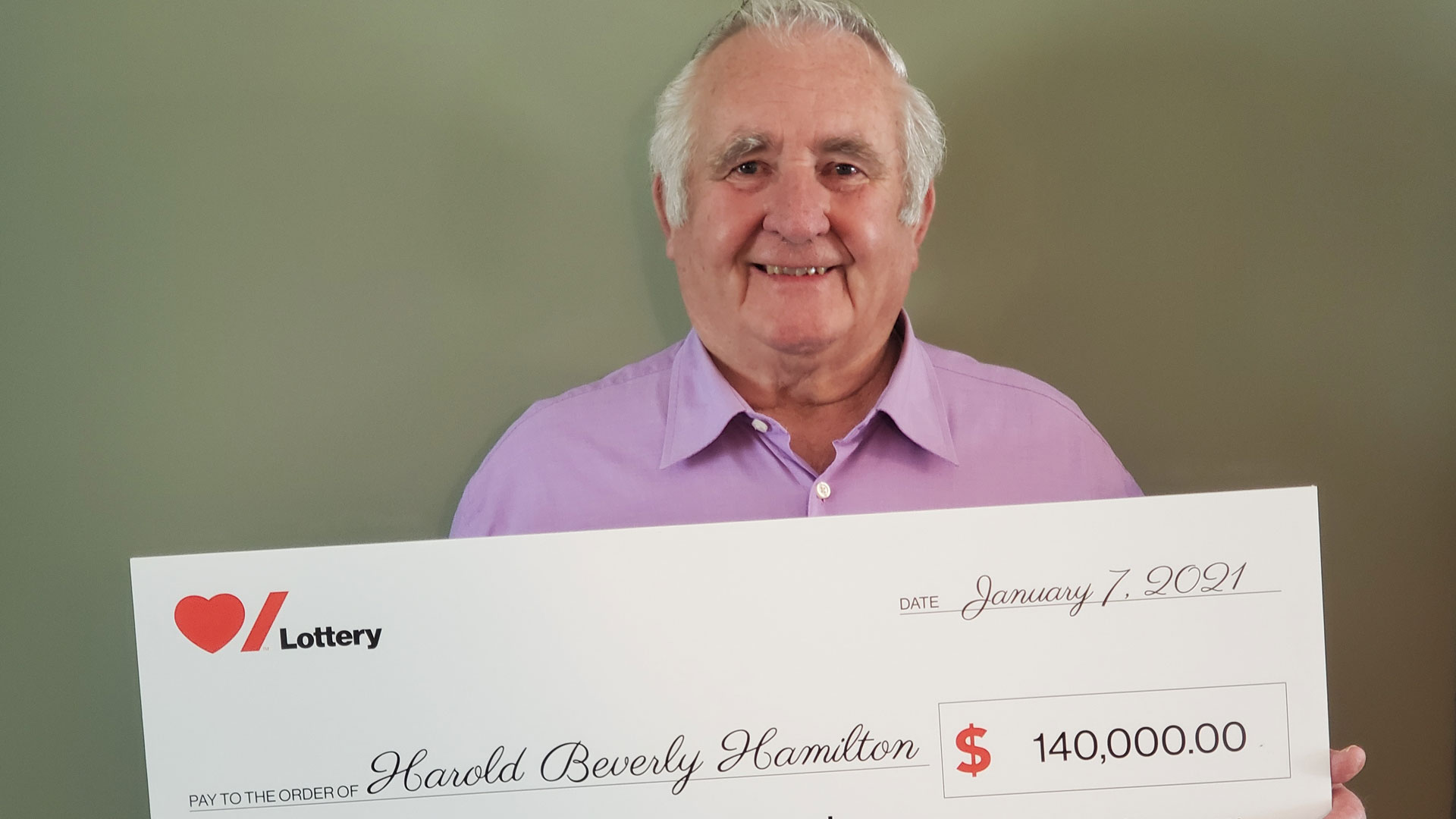 Elderly man standing against brown background 