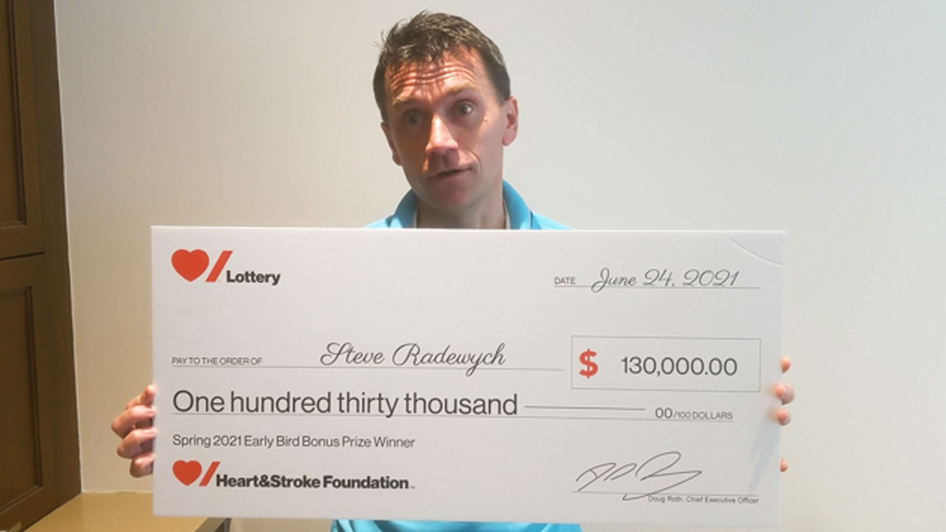 Man holding large novelty cheque 