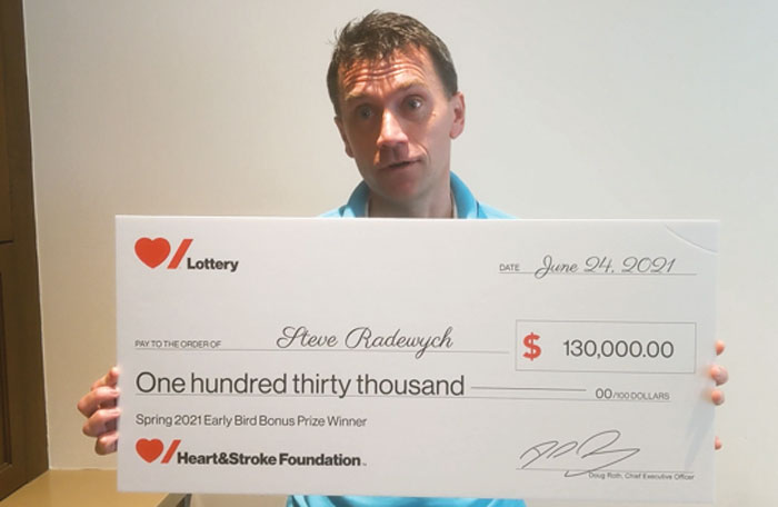 Man holding large novelty cheque