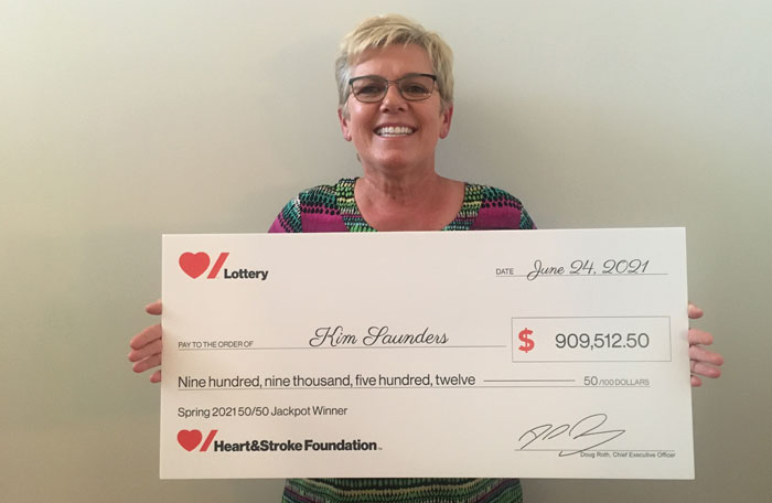 Women holding large novelty cheque 
