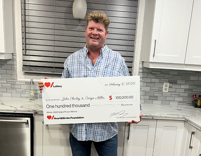 John Chorley holding the cheque