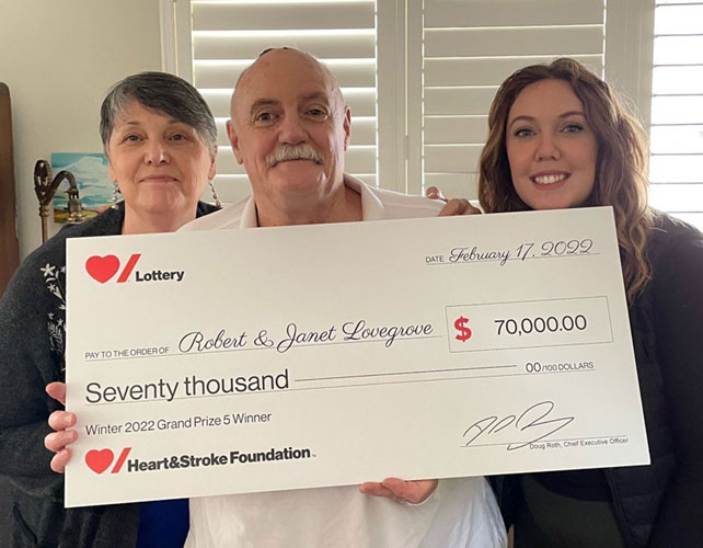 Robert Lovegrove holding the novelty cheque