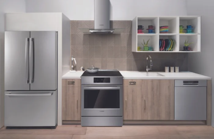 A kitchen with stainless steel refrigerator, dishwasher and range.