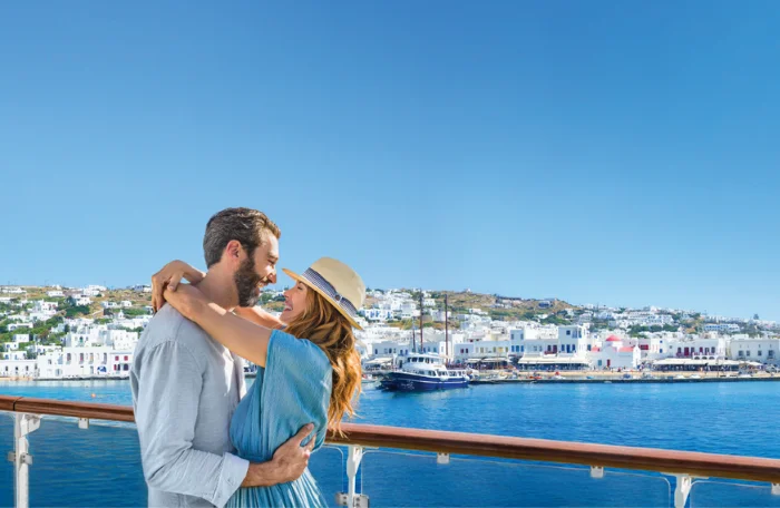 A couple embracing on a cruise ship docked in Greece