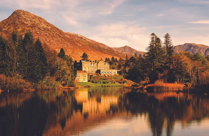 A view of an Irish castle reflecting on a lake