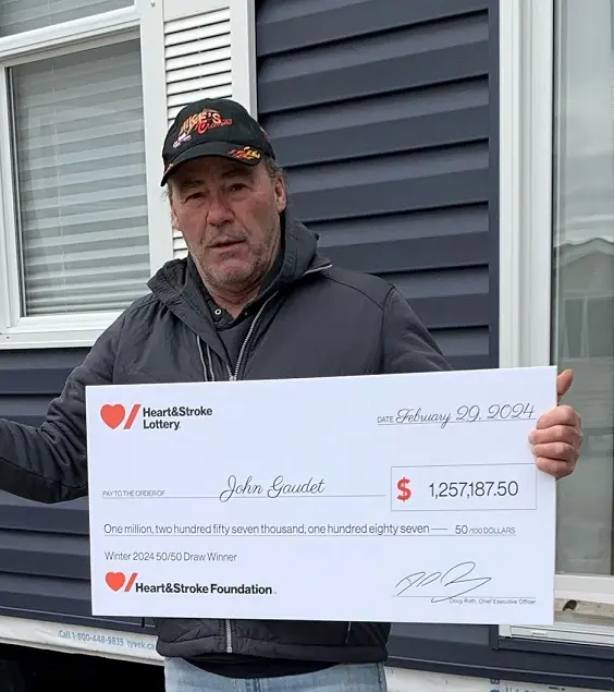 Heart & Stroke Lottery Winter 2024 50/50 Draw winner holding a cheque for $1,257,187.50