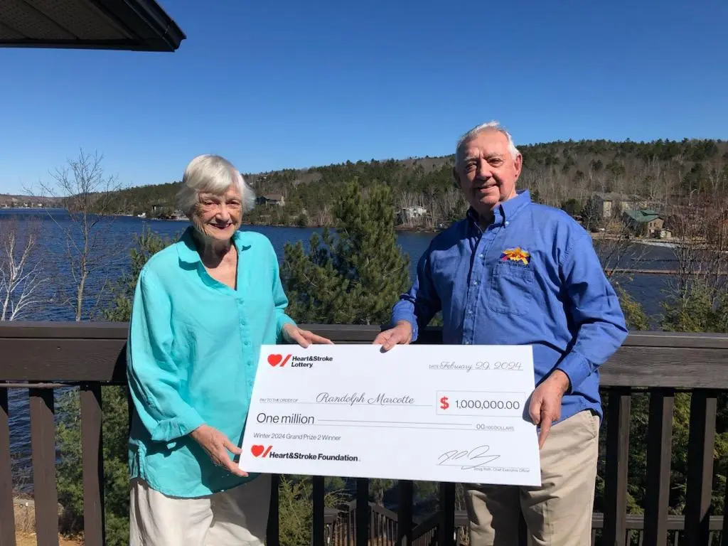 Randy and Barb Marcotte holding a cheque