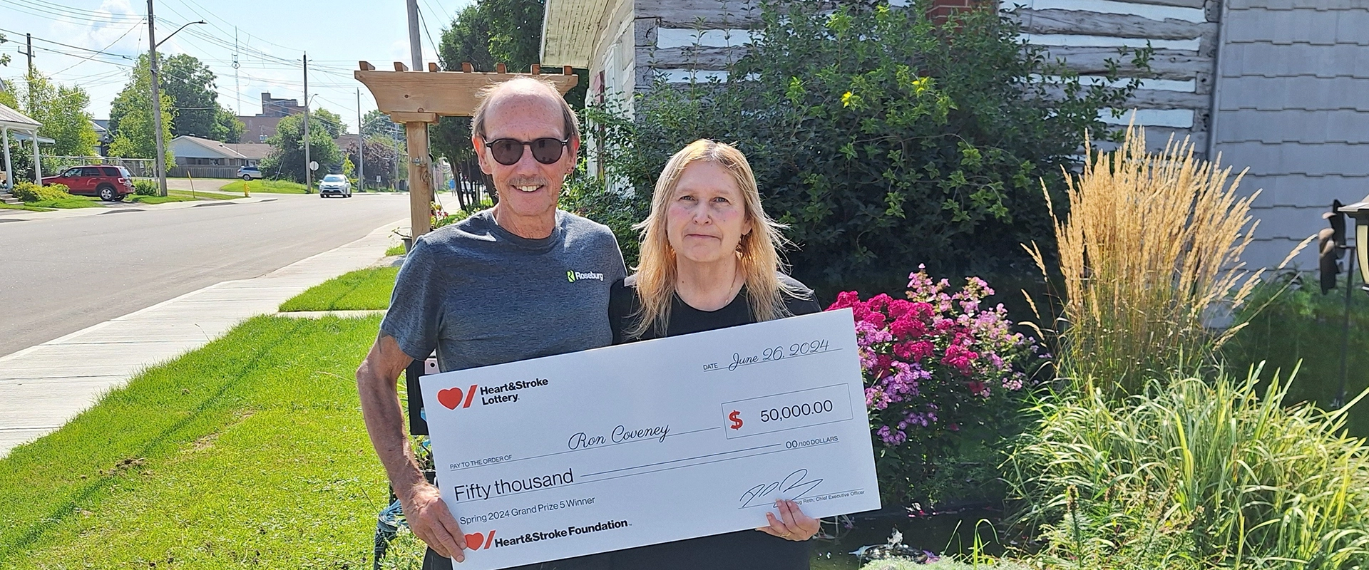 Ron Coveney and his partner Cindy hold a Heart & Stroke cheque for $50,000