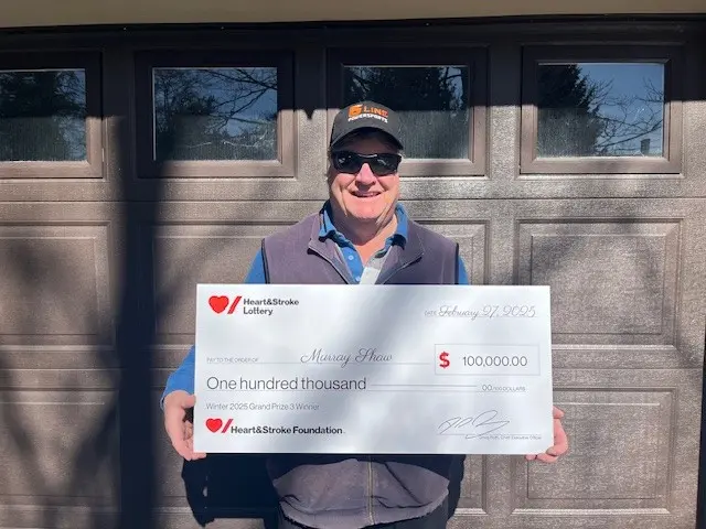Winter 2025 Grand Prize #3 Winner with his novelty cheque of $100,000.