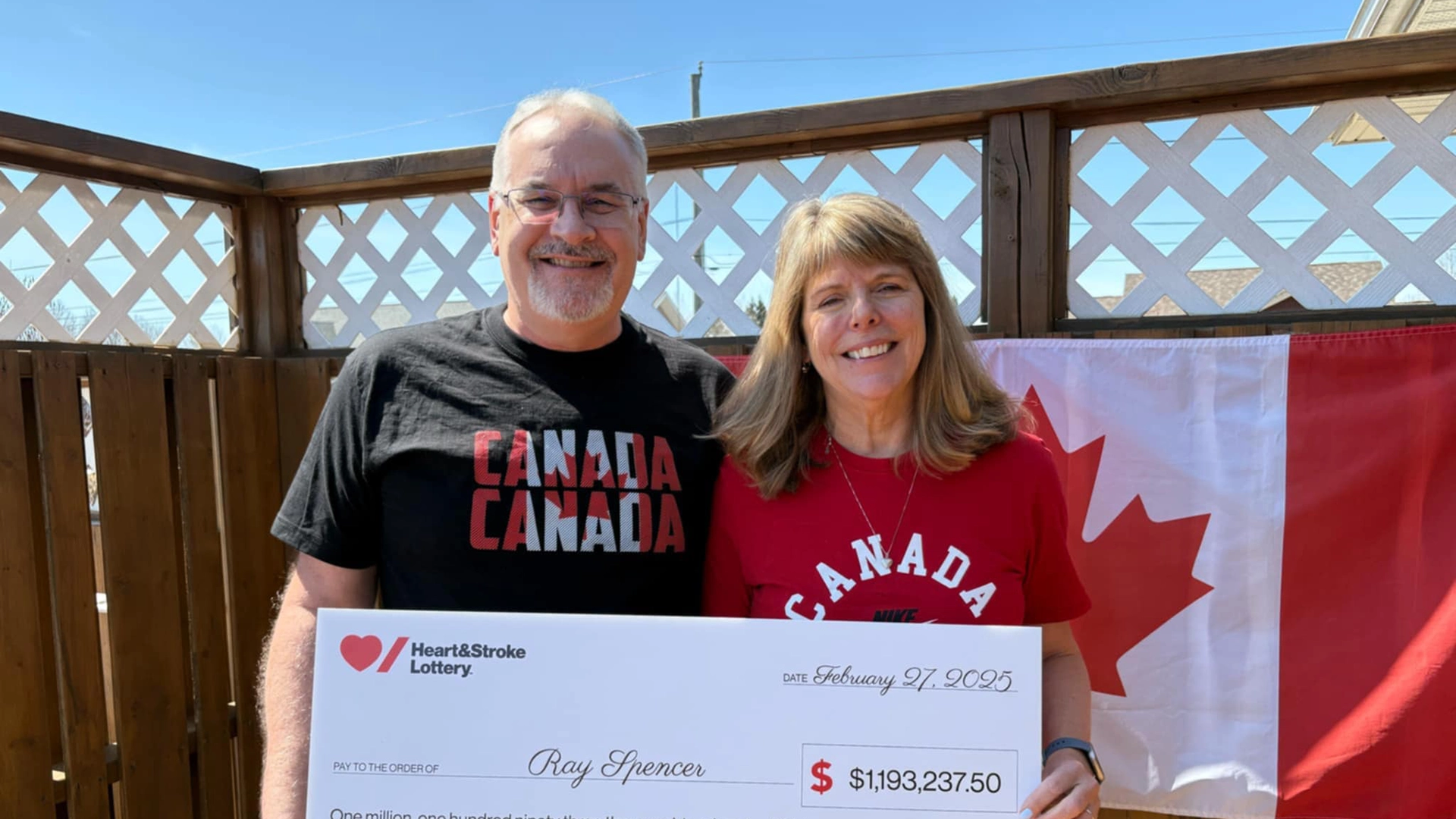 Winter 2025 – 50/50 Prize Winner Ray Spencer holding a novelty cheque for his winning.