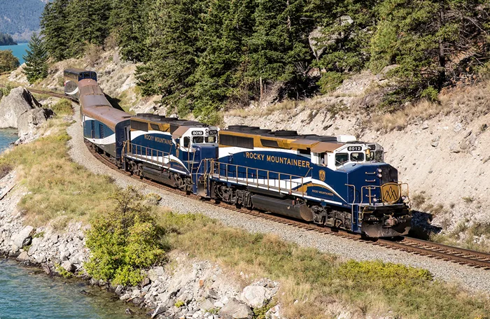 Image showing a train next to a lake.