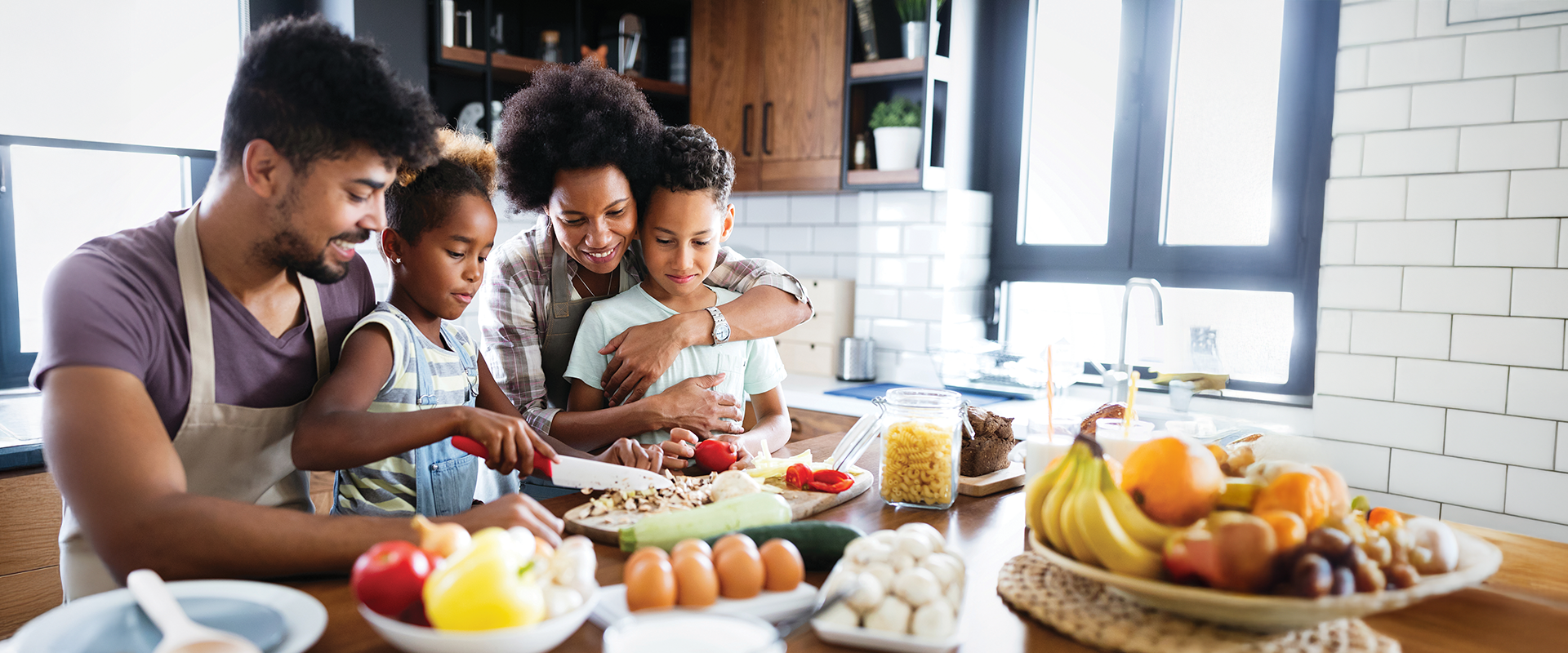 A family of 4 including 2 kids enjoying a healthy, wholesome, nutritious breakfast at the table