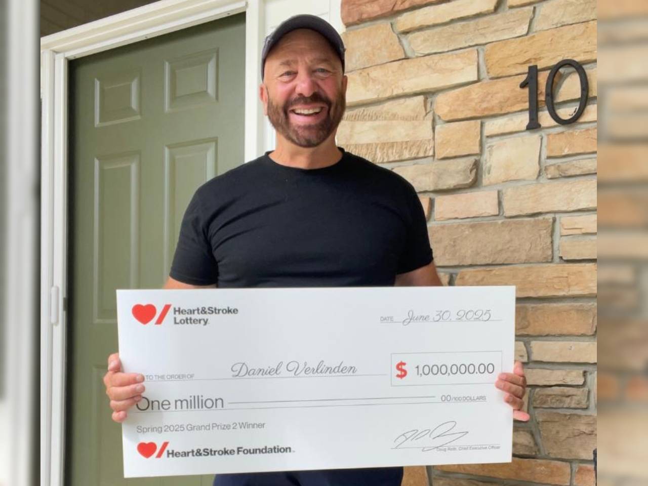 Spring 2025 Lottery – Grand Prize 2 Winner Danny Verlinden holding a novelty cheque for his winning.    