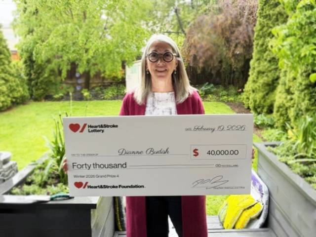 Winter 2026 Lottery – Grand Prize 4 Winner Dianne B. holding a novelty cheque for her winning.   